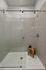 Luxurious modern shower area with elegant glass doors, tiled walls, and stylish bamboo stool for a spa-like experience.