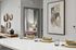 Modern apartment interior with a stylish kitchen counter featuring elegant dishware and artistic wall decor, leading into a cozy bedroom with soft lighting.