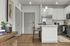Modern kitchen with sleek white cabinetry, elegant island seating, and stylish lighting, perfect for urban living.