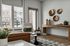 Bright and stylish living room with modern decor, featuring large windows, a chic armchair, and a decorative console table.
