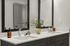 Modern bathroom with dual sinks, sleek dark cabinets, and elegant decor accents, perfect for a stylish city apartment.