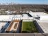 Expansive urban rooftop terrace with sleek seating areas, vibrant greenery, and captivating city views.