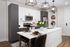 Modern kitchen with sleek white cabinetry, stainless steel appliances, and an elegant island with seating, accented by contemporary pendant lighting.
