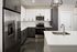 Modern kitchen with sleek stainless steel appliances, elegant cabinetry, quartz countertops, and stylish subway tile backsplash.