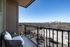 Chic apartment balcony offering stunning city skyline views, perfect for relaxation and enjoying urban living.