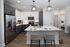 Chic modern kitchen with sleek stainless steel appliances, elegant cabinetry, and a stylish island with seating for two. Bright, inviting, and perfect for entertaining.