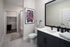 Contemporary bathroom featuring sleek dark cabinetry, modern fixtures, and vibrant wall art, with an inviting shower and ample closet space.