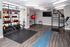 Modern fitness room with sleek hardwood floors, vibrant kettlebells, and versatile exercise equipment; perfect for a dynamic workout experience.