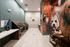 Modern pet washing station with sleek sinks and a vibrant mural of dogs, offering a stylish and convenient amenity for pet owners.