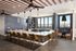 Sophisticated communal kitchen with chic bar seating, modern pendant lights, and a panoramic window view.