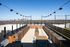 Stunning rooftop terrace with modern seating, planter boxes, and a breathtaking city skyline view.