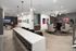 Chic lounge area with stylish seating, contemporary artwork, and elegant lighting in a modern apartment building.