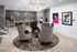 Contemporary lounge featuring elegant patterned chairs, stylish lighting, and modern art on display.