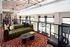 Chic open-concept living area with elegant modern furniture, vibrant decor, and large windows providing natural light.
