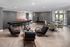 Modern lounge area with elegant seating, accent tables, and sleek floors, perfect for social gatherings or relaxation.