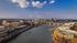 Breathtaking aerial view of a vibrant cityscape with a beautiful river, impressive skyline, and elegant bridges. Ideal urban living with scenic beauty.