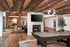 Chic entertainment suite featuring a stylish billiards table, cozy fireplace, and elegant lounge area with rich wooden accents.