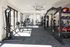 Modern fitness center with state-of-the-art equipment, ample natural light, and spacious workout areas.