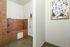 Stylish pet washing station featuring modern brown tiles and a charming dog artwork, perfect for pet-friendly living.