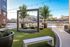 Chic outdoor seating area with stylish furniture and water feature, nestled beside a scenic river view and modern architecture.