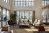 Bright, sophisticated living room with high ceilings, large windows, and chic modern decor, ideal for relaxation and entertaining.