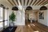 Elegant entryway and inviting dining area with modern decor, featuring warm wood flooring, spacious seating, and stylish lighting.