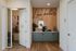 Inviting modern space featuring a cozy phone booth and stylish refreshment area under 'Live better' sign.