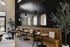 Sophisticated dining area with elegant leather seating, modern pendant lighting, and lush greenery, offering a welcoming ambiance.