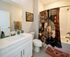 Charming bathroom with elegant floral shower curtain, modern vanity, and stylish decor pieces.
