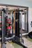 Modern gym equipment in a bright fitness room featuring versatile strength training machines and vibrant red medicine balls.