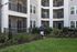 Modern apartment exterior with private balconies, beautiful landscaping, and a welcoming atmosphere.