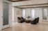 Contemporary shared workspace lounge with plush seating, elegant wood paneling, and modern art decor.