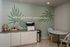 Inviting workspace with motivational wall art, featuring a stylish cabinet, modern printer, and cozy seating area.
