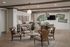 Chic living area featuring elegant wicker chairs, stylish decor, and a contemporary dining space with motivational art on the wall.