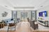 Elegant living room with modern decor, featuring a cozy blue sectional, stylish armchairs, and a large flat-screen TV. Abundant natural light streams in through the windows, highlighting the chic design and welcoming ambiance.