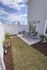 Charming outdoor patio with cozy seating and lush greenery, perfect for relaxing or entertaining.