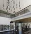 Modern gym interior with sleek workout equipment and stylish hanging lights, offering a luxurious fitness experience.