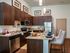 Gourmet kitchen with dark cabinetry, stainless steel appliances and granite countertops