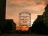 Stunning sunset over Magic City, featuring the iconic Rotary Trail sign against a vibrant sky.