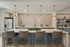 Modern kitchen with an elegant marble island, stylish pendant lighting, and sleek stainless steel appliances.