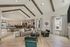 Spacious open-concept living area with vaulted ceilings, modern decor, and natural light. Features a stylish kitchen and comfortable seating, perfect for entertaining.