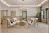 Elegant living area with modern chairs, stylish circular chandelier, and cozy decor, exuding a welcoming ambiance in a well-lit space.