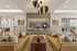 Elegant modern lounge with chic sofas, a sleek marble coffee table, and stylish lighting accents, ideal for relaxation or gatherings.