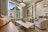 Chic apartment living area boasting modern decor, plush seating, and abundant natural light through large windows.