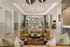 Elegant and spacious living room with luxurious seating, modern chandelier, and large windows offering ample natural light.