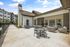 Beautiful outdoor patio space featuring comfortable seating, a modern table, and lush greenery, perfect for relaxation and gatherings.