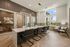 Elegant meeting room featuring a long modern table, sleek chairs, large bright windows, and contemporary lighting fixtures.