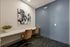 Chic workspace nook with elegant chairs, modern art, and a cozy ambiance perfect for productivity.