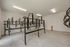 Modern bike storage room with sleek metal racks, ample space, and bright lighting for secure and organized bicycle parking.