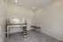 Modern pet grooming station with sleek stainless steel bath and convenient tiled walls, perfect for pet-friendly apartments.